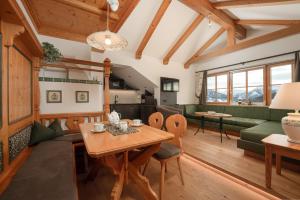 a living room with a table and a couch at Brandhof in Ramsau am Dachstein