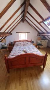 a bedroom with a large bed in a attic at Ciel Etoillè in Saint-Bonnet-de-Four