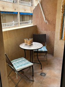 a table and chairs in a room with a balcony at Casa La Mata in La Mata