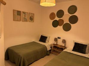 a bedroom with two beds and a table with lamps at Casa La Mata in La Mata