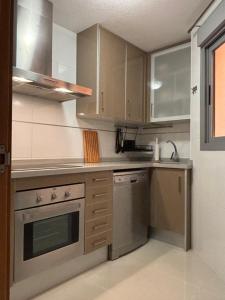 a kitchen with stainless steel appliances and cabinets at Casa La Mata in La Mata