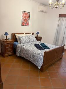 a bedroom with a bed and two night stands at Casa do Cabo Alto in Areal +14 photos