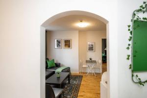 a living room with a couch and a table at Quiet & Walkable - Stampede, BMO, Nightlife & Eats in Calgary