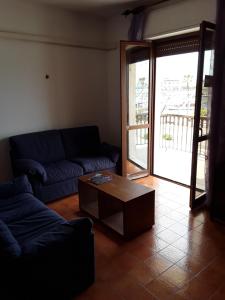 a living room with a couch and a coffee table at L'Aragosta Guesthouse in Alghero +30 photos