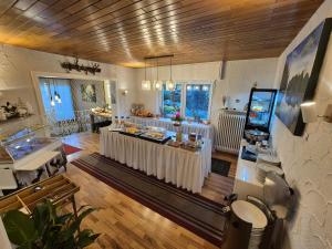 a large room with a bar with white tables at Landhotel Schönblick in Bad Herrenalb