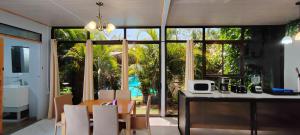 a kitchen and dining room with a large glass window at Ballena Rey Hotel in Uvita