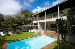 a house with a swimming pool in front of it at The Hub Urban Hotel in Port Elizabeth