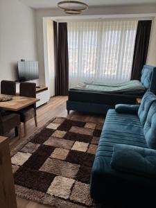 a living room with a couch and a table at Mecks apartmani in Novi Pazar