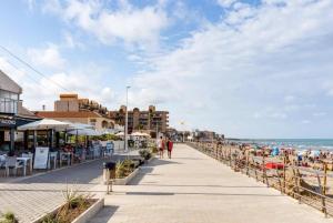 a boardwalk along the beach in a resort at Casa La Mata in La Mata