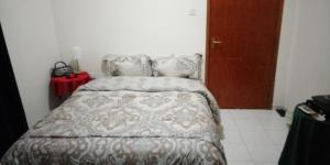 a bedroom with a bed and a red table at Beachside Vacation House in Ras al Khaimah