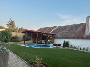 a house with a swimming pool in a yard at Apartmány u Pálavy in Přítluky