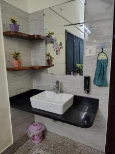 a bathroom with a sink and a mirror at The Rest Nest in Gorakhpur +13 photos