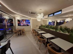 a row of tables and chairs in a restaurant at Zemun Golax Apartments in Belgrade