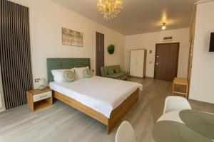 a bedroom with a bed and a living room at Sasha Collection by AlezziNord10 in Constanţa