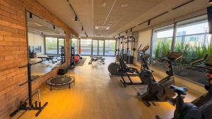 a gym with treadmills and cardio machines in a room at Almagah 227 - Studios de Alto Padrão no Tatuapé - SP in São Paulo