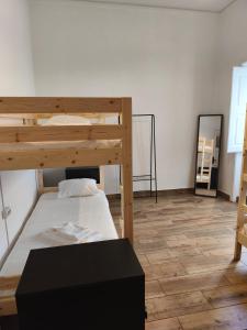 a bedroom with a bunk bed and a mirror at Chill Spot - Faro Hostel in Faro