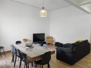 a living room with a table and a couch at Chill Spot - Faro Hostel in Faro