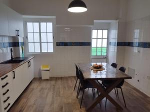 a kitchen with a table with a bowl of fruit on it at Chill Spot - Faro Hostel in Faro