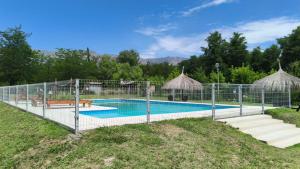 a swimming pool with a fence around it at Complejo de cabañas Vida Paz in Las Calles
