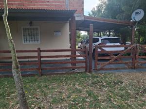 a wooden fence in front of a house at Sueño magico in Chapadmalal