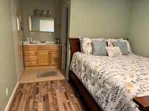 a bedroom with a bed with a sink and a mirror at RR-Birch_Creek 2 in June Lake