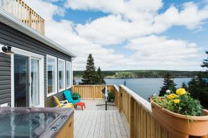 a porch of a house with a view of the water at Whale House Guest House in Mobile