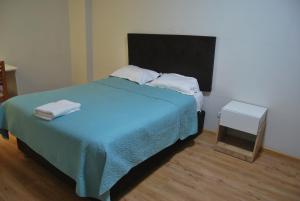 a bedroom with a bed with two towels on it at Kymeron Hotel in Juliaca +2 photos