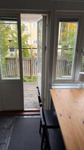 a dining room with a table and a sliding glass door at Ribe Villa in Stockholm +16 photos