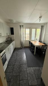 a kitchen with a table and a table and chairs at Ribe Villa in Stockholm