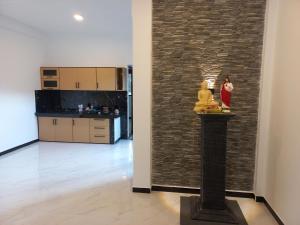a room with a brick wall and a woman in a red dress at Calm Stay in Badulla +50 photos