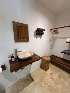 a bathroom with a sink on a wall at la baxada mazunte in Mazunte