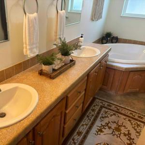 a bathroom with two sinks and a tub and a bath tub at The Lodge in O'Brien +35 photos