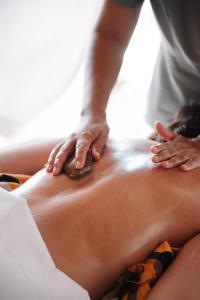 a woman getting a massage on her back at Petit Lafitte Beach Front Hotel & Bungalows in Playa del Carmen