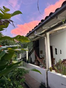a balcony of a house with a pink at Hostal El Amate #1 in Suchitoto