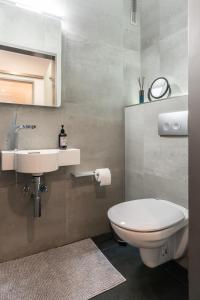 a bathroom with a white toilet and a sink at Auszeit in Bad Zwischenahn +9 photos
