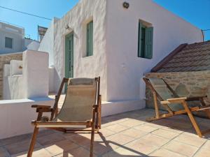 a chair on a patio in front of a house at Symi Village House in Symi