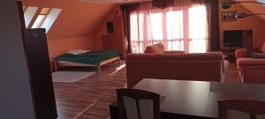 a living room with a couch and a table at ELEKTRa in Stare Bielice