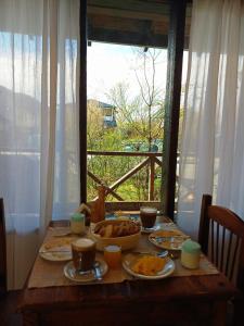 a wooden table with food on it with a window at Casa Viedma in El Chalten +15 photos