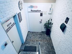 a door in a hallway with a sign that reads reception at Hotel Royal in Leopoldshöhe