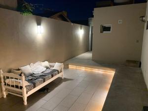 a bedroom with a bed in a room with lights at Depto Amonite Mar Caribe in Puerto Madryn