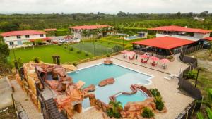 an aerial view of a pool and a tennis court at Kindia Park Hotel in La Esmeralda