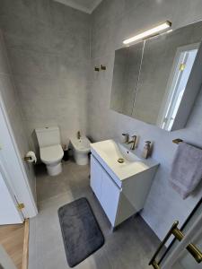 a bathroom with a sink and a toilet and a mirror at Atlantic Dreams II in Pico da Pedra +14 photos
