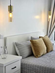 a bedroom with a bed with two pillows and a table at Atlantic Dreams II in Pico da Pedra