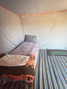 a bedroom with a bed in a tent at Bivouac Porte du Désert in Mhamid +31 photos