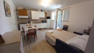 a bedroom with a bed and a kitchen with a table at L'Alba della Tavernetta in Locorotondo