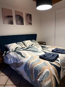 a bedroom with a bed with clothes on it at A Casa di Diego - Appartamento nel cuore della Toscana in Poggibonsi