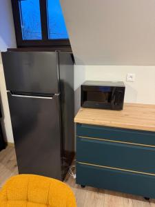 a kitchen with a refrigerator and a microwave at Apartman Mia 5 in Liptovský Mikuláš +9 photos
