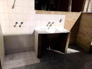 a bathroom with a sink and a shower at Casa Encanto in Mar de las Pampas +13 photos