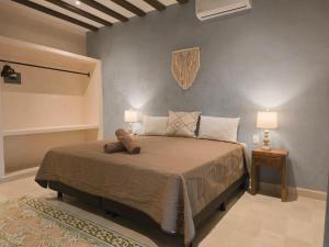 a bedroom with a large bed with two lamps at Casa Lucia Valladolid in Valladolid