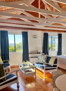a living room with a bed and a couch at Sunny studio in the sky in Brenton-on-Sea